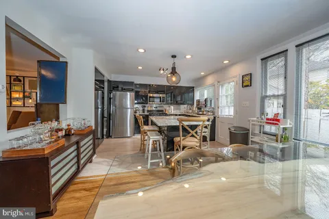 a living room with lots of furniture and kitchen view