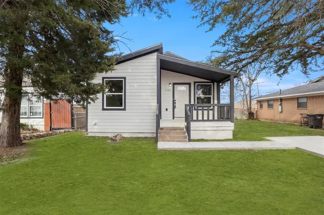 a view of a house with a yard and tree s