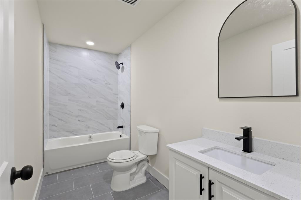 5124 Kilpatrick Avenue Fort Worth, TX 76107 - Photo 11 of 31 a bathroom with a sink a toilet and shower