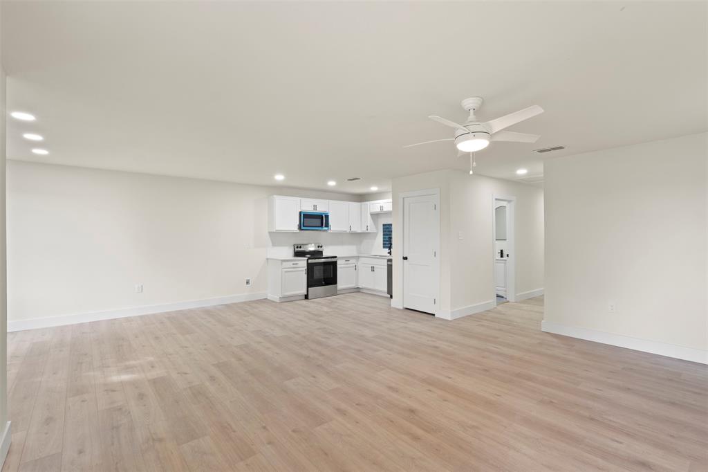 5124 Kilpatrick Avenue Fort Worth, TX 76107 - Photo 5 of 31 a view of an empty room with kitchen view and a window