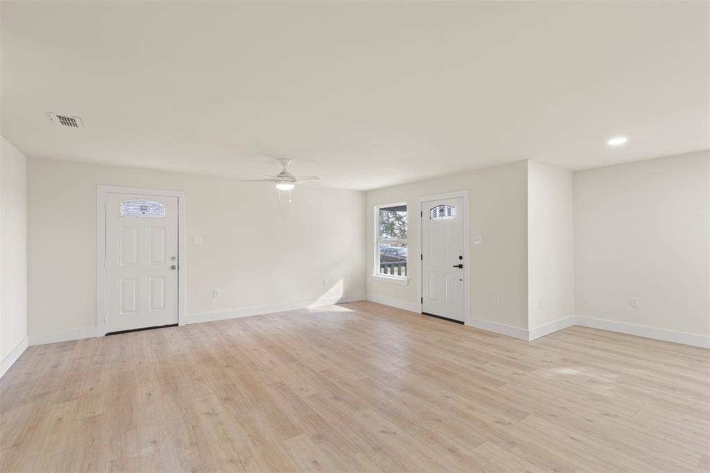 5124 Kilpatrick Avenue Fort Worth, TX 76107 - Photo 6 of 31 an empty room with wooden floor and windows