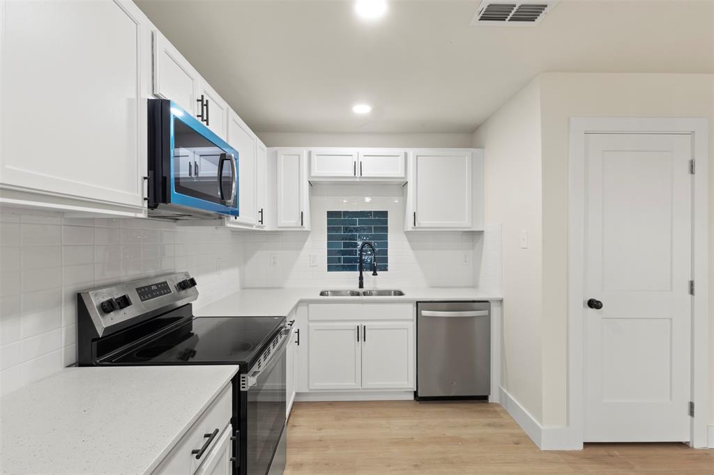 5124 Kilpatrick Avenue Fort Worth, TX 76107 - Photo 9 of 31 a kitchen with a sink a stove and cabinets