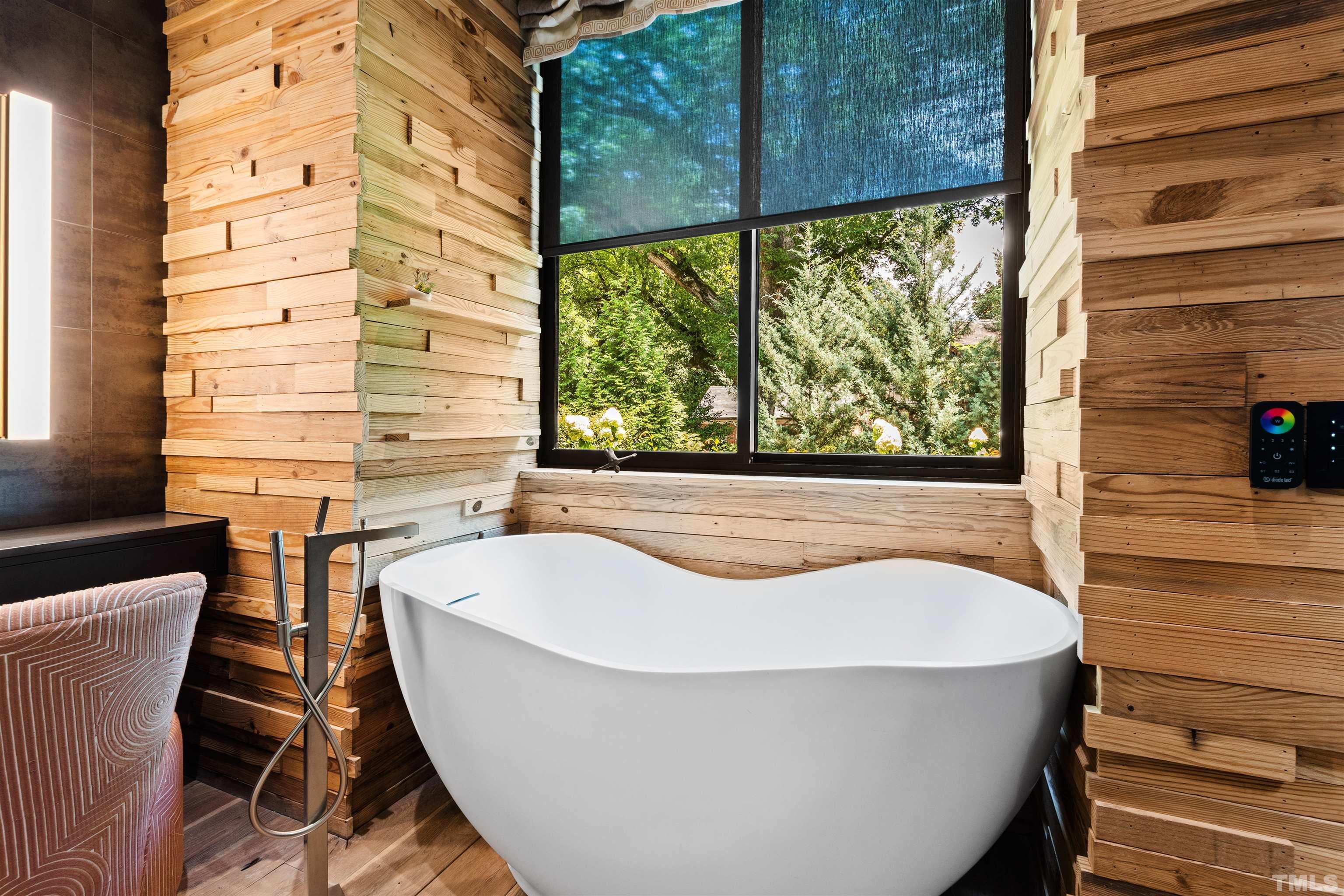 2315 Beechridge Road Raleigh, NC 27608 - Photo 19 of 78 a bathroom with a bathtub and window