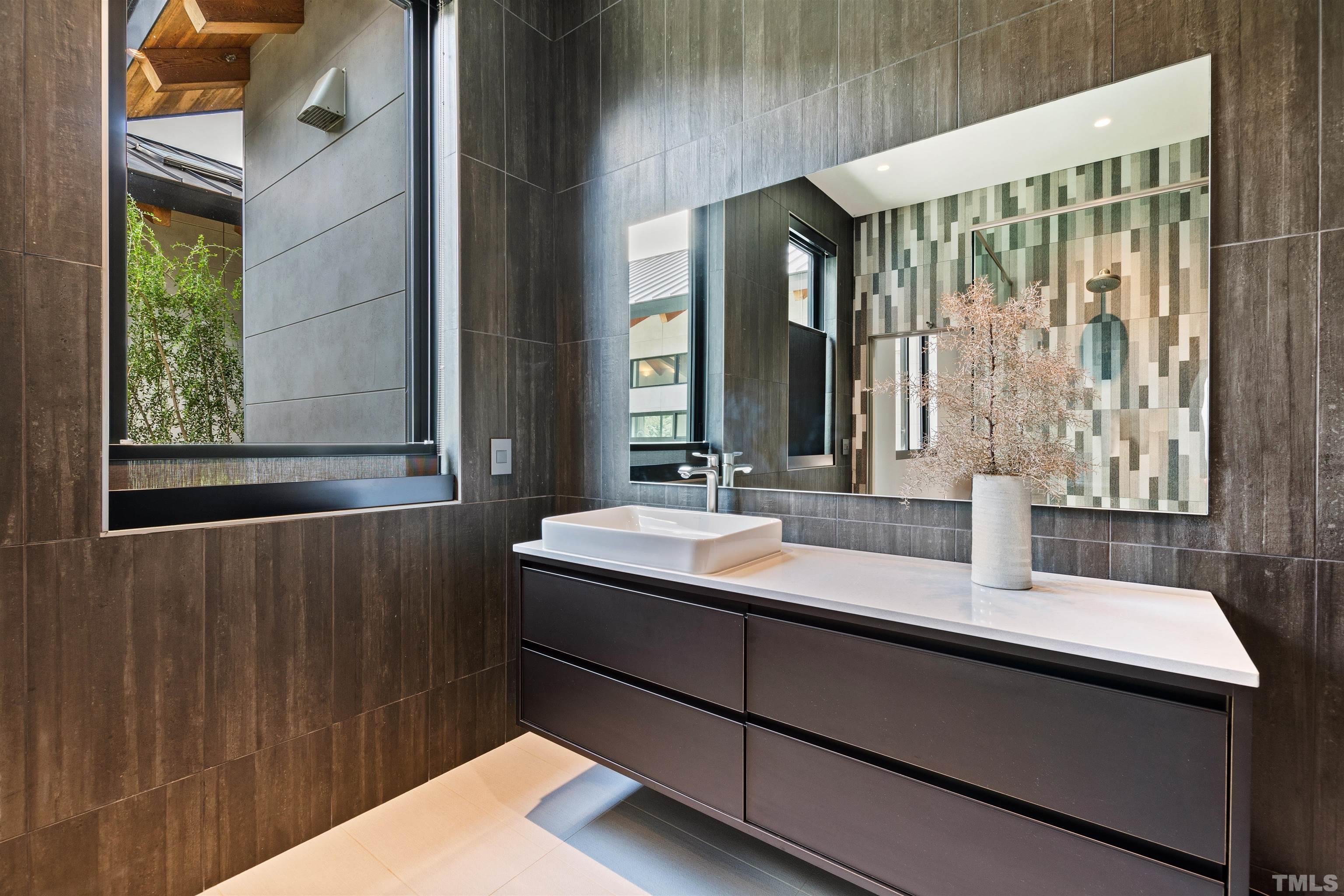 2315 Beechridge Road Raleigh, NC 27608 - Photo 32 of 78 a bathroom with a sink and a mirror