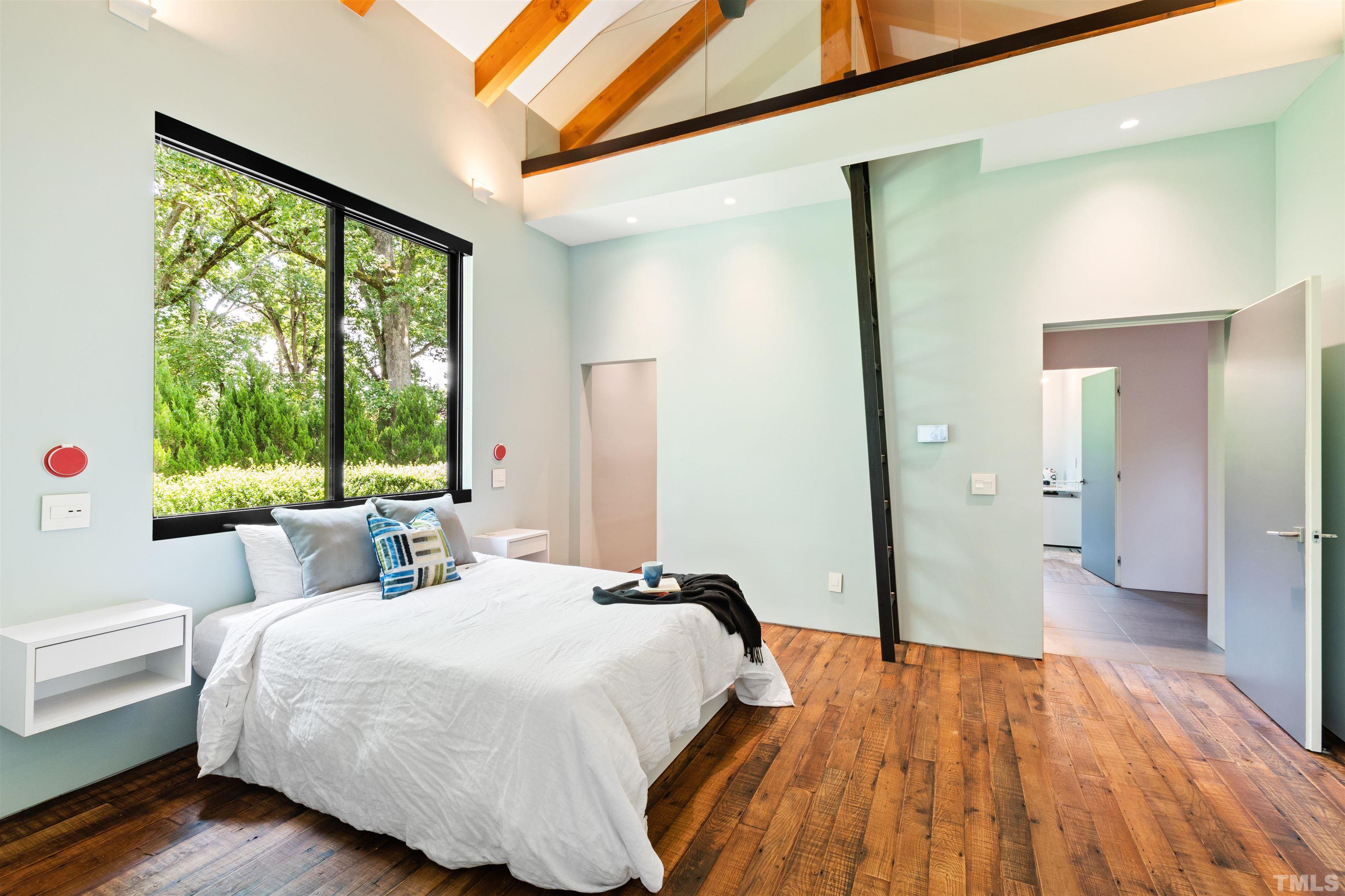 2315 Beechridge Road Raleigh, NC 27608 - Photo 36 of 78 a bedroom with a bed and a large window