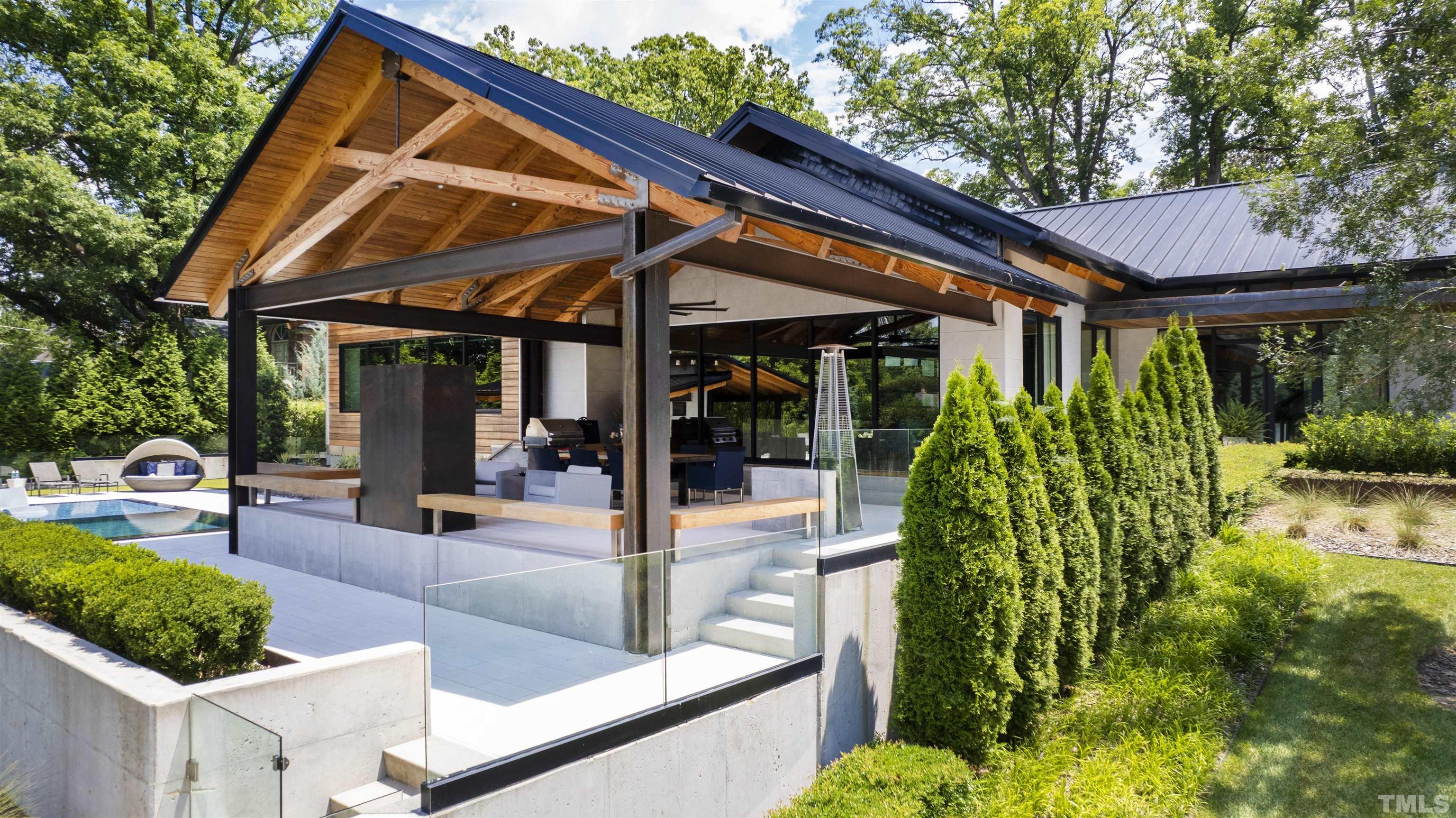 2315 Beechridge Road Raleigh, NC 27608 - Photo 53 of 78 a view of patio with a table and chairs under an umbrella