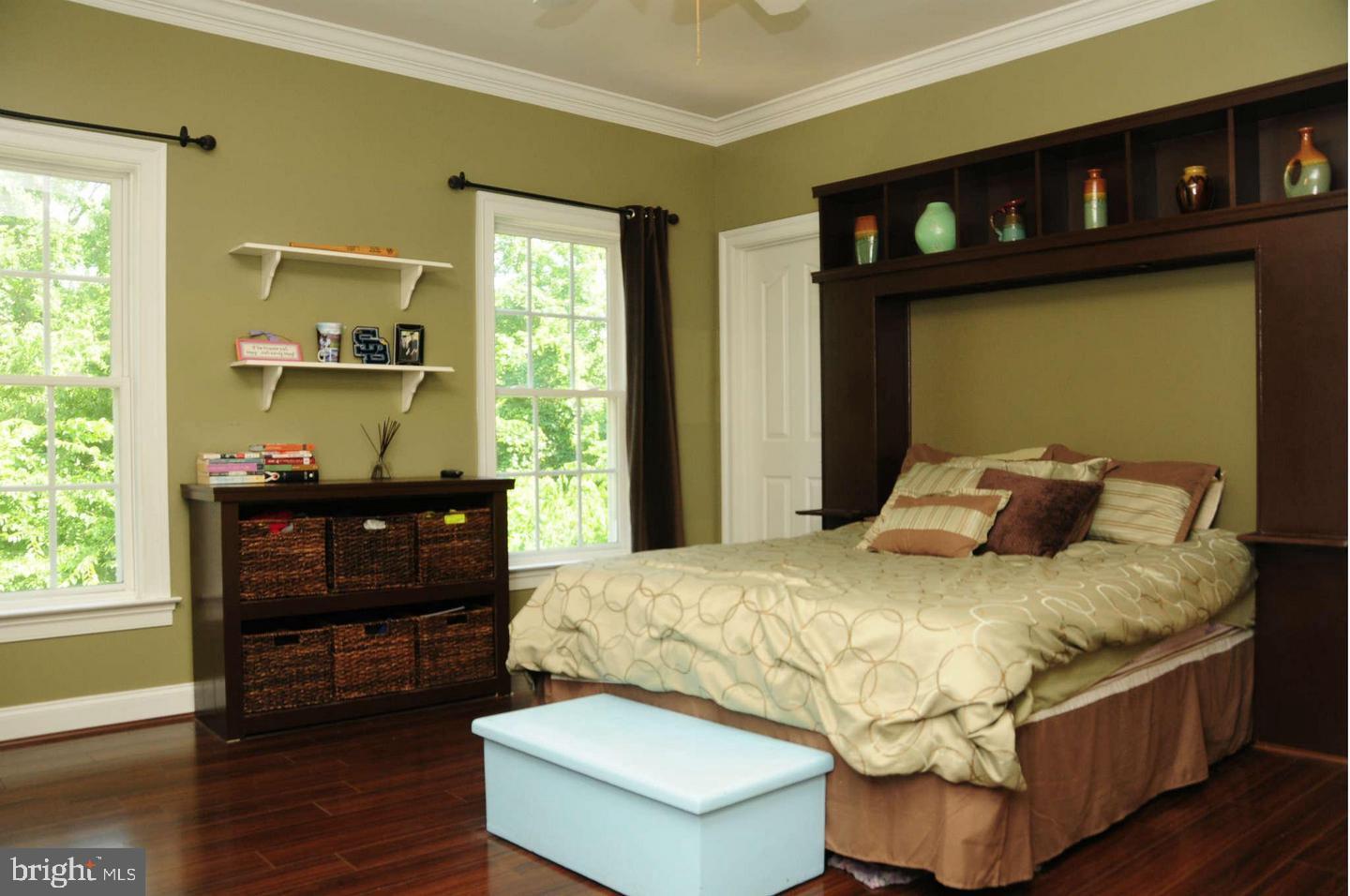 19123 Stream Crossing Court Leesburg, VA 20176 - Photo 15 of 30 a bedroom with a bed and wooden floor
