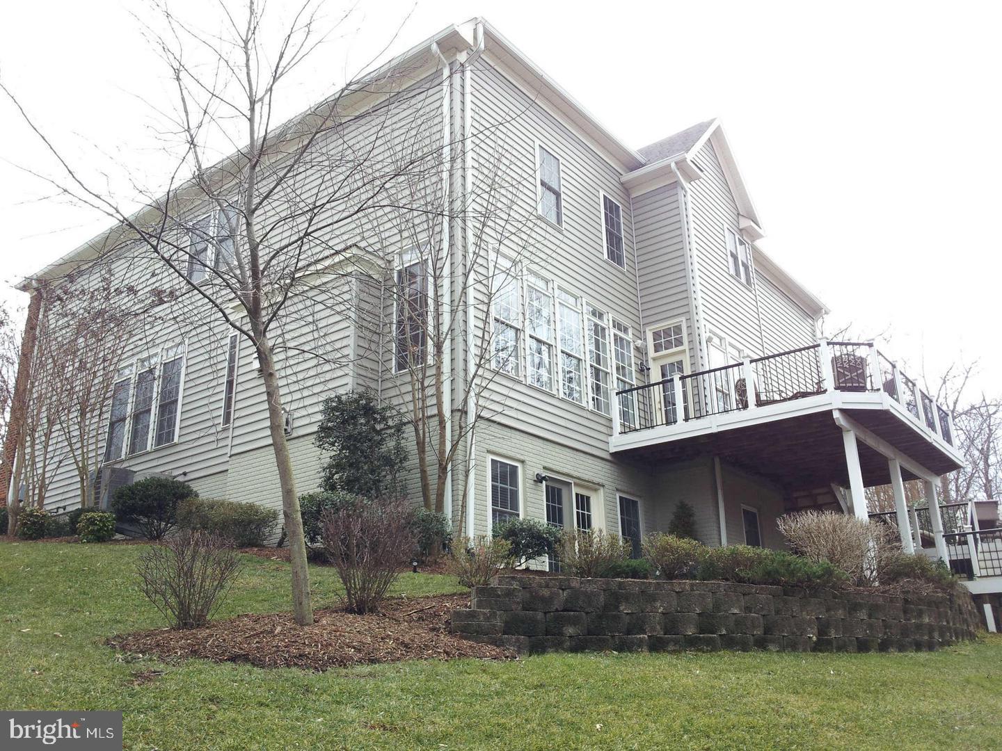 19123 Stream Crossing Court Leesburg, VA 20176 - Photo 26 of 30 a view of a white house next to a yard