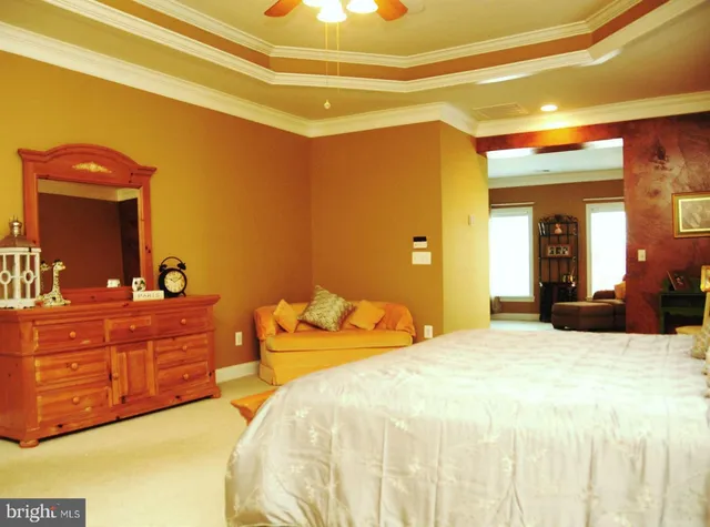 a bed sitting in a room next to a window