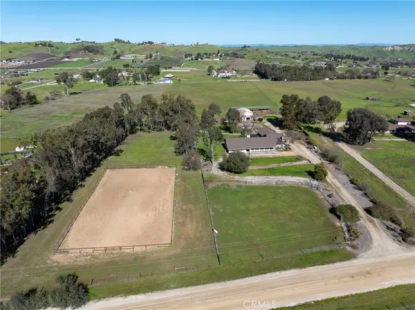 an aerial view of a house with a yard lake view and mountain view