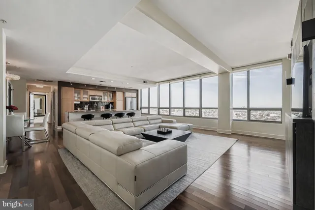 a living room with fireplace furniture and a wooden floor