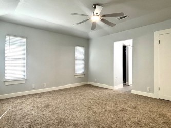 3416 Primrose Trail Georgetown, TX 78628 - Photo 24 of 35 an empty room with windows and fan chandelier