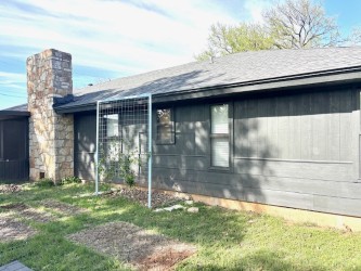 3416 Primrose Trail Georgetown, TX 78628 - Photo 5 of 35 View of side of property with a chimney, a shingled roof, and a lawn