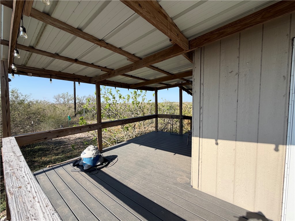 375 Trail Ridge Drive Sandia, TX 78383 - Photo 15 of 17 a view of a balcony with wooden floor and iron stairs