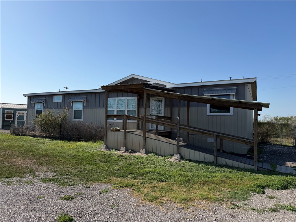 375 Trail Ridge Drive Sandia, TX 78383 - Photo 2 of 17 a backyard of a house with wooden fence and a bench