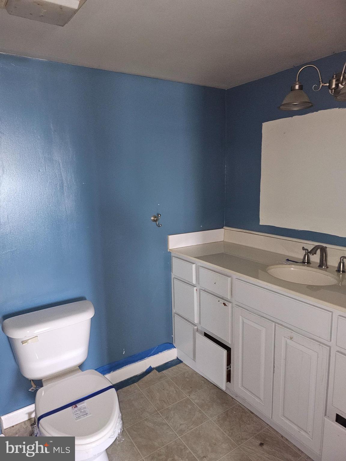 1261 Main Street Harrisburg, PA 17113 - Photo 9 of 10 a bathroom with a toilet sink and mirror