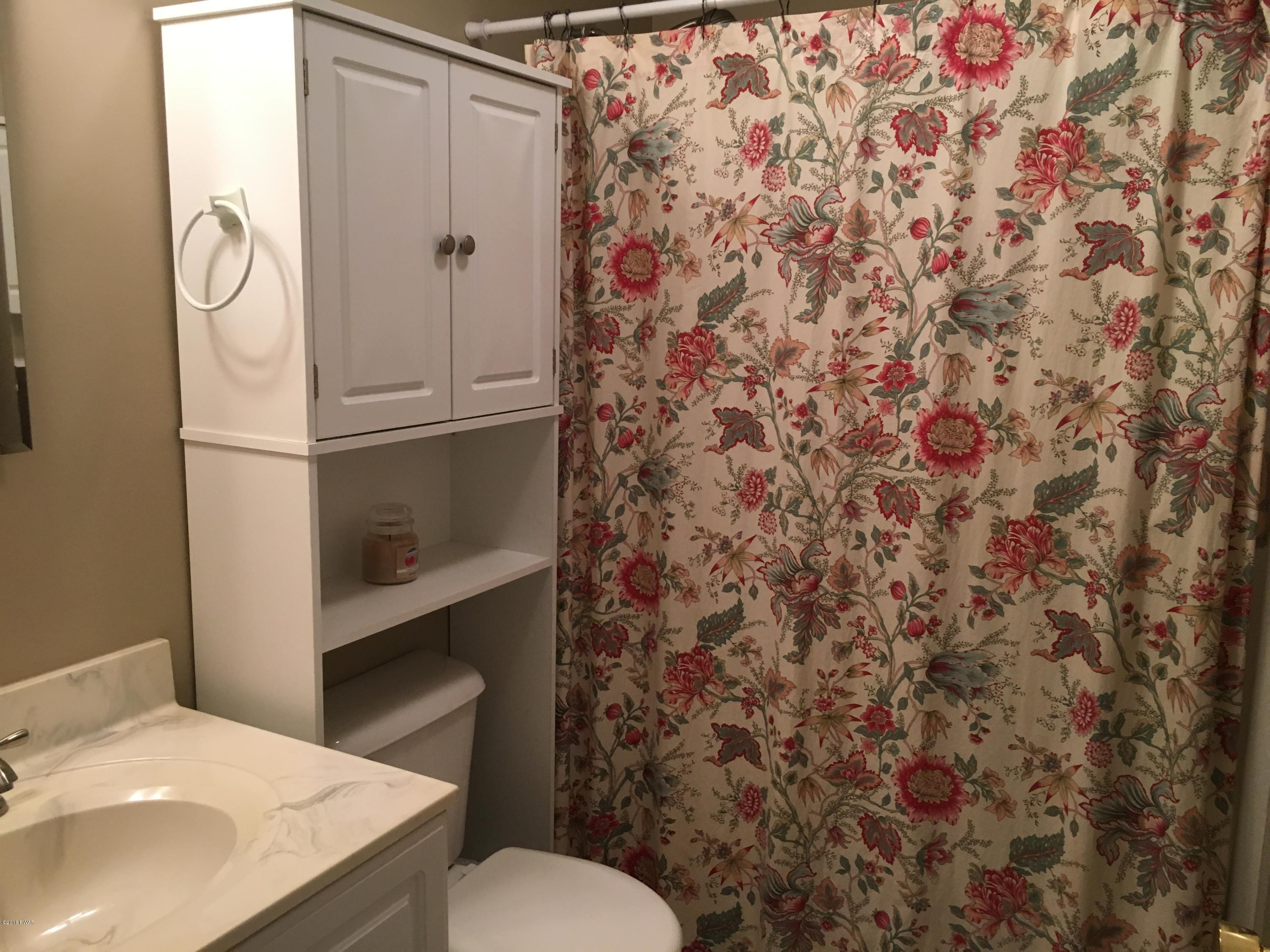 154 Butternut Road Milford, PA 18337 - Photo 11 of 14 a bathroom with a sink and mirror with toilet