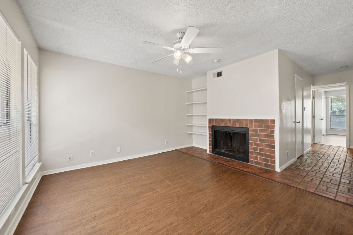 2110 Rio Grande Street, Unit 306 Austin, TX 78705 - Photo 4 of 10 an empty room with windows and fireplace