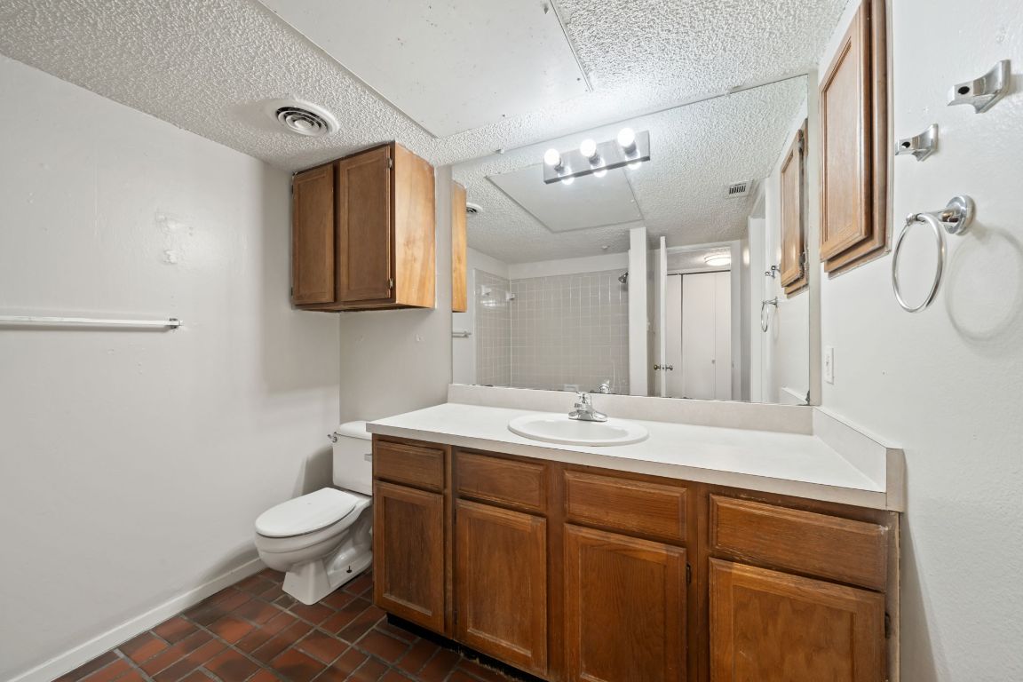 2110 Rio Grande Street, Unit 306 Austin, TX 78705 - Photo 7 of 10 a bathroom with a toilet sink and mirror