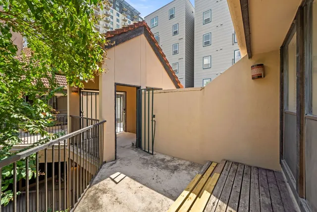 a view of balcony with wooden floor and fence