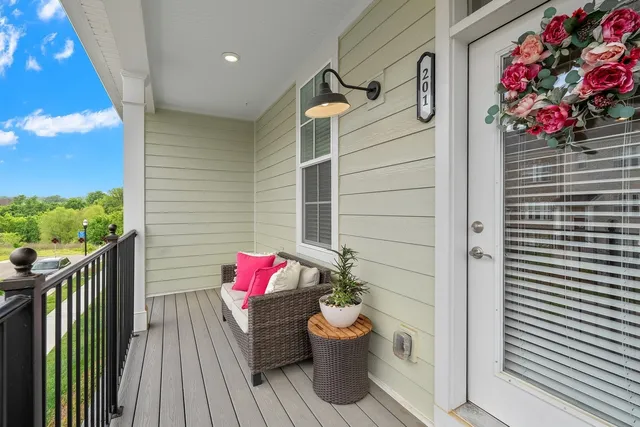a walk in closet with wooden floor