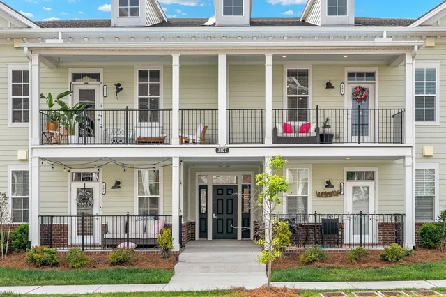 a view of staircase with wooden floor and white walls