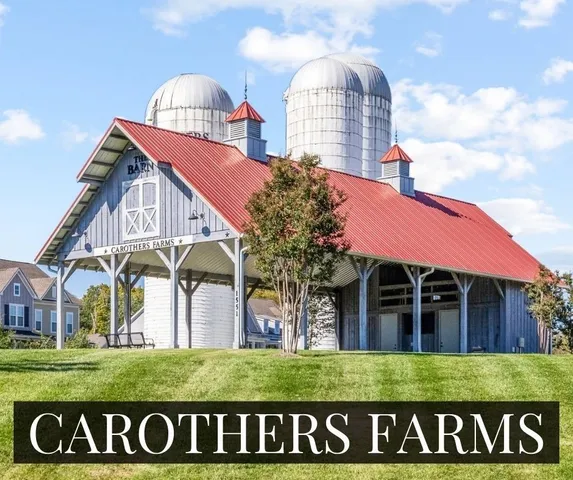 a view of a big building with a big yard and large trees