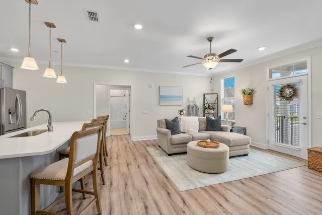 a living room with furniture a rug and a flat screen tv