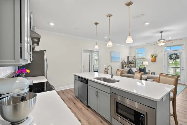 a kitchen with stainless steel appliances granite countertop a sink stove and refrigerator