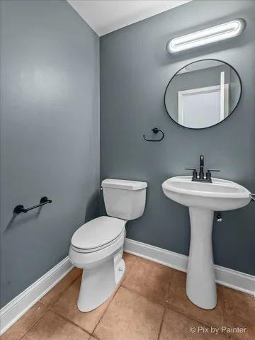 a bathroom with a sink toilet and a mirror