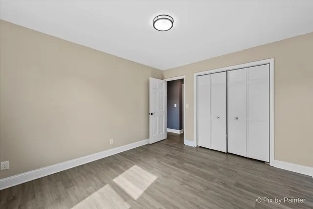 a view of an empty room and wooden floor