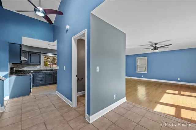 a view of a kitchen with a sink and a refrigerator