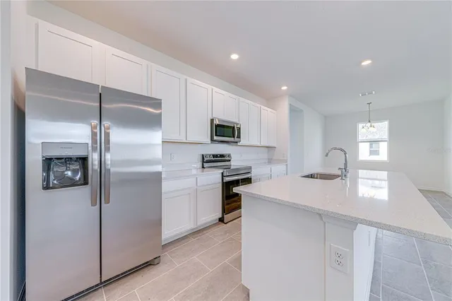 a kitchen with cabinets and stainless steel appliances