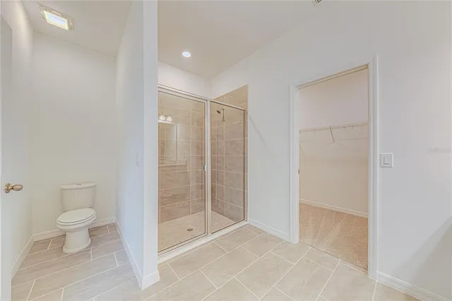 a bathroom with a shower a toilet and a sink