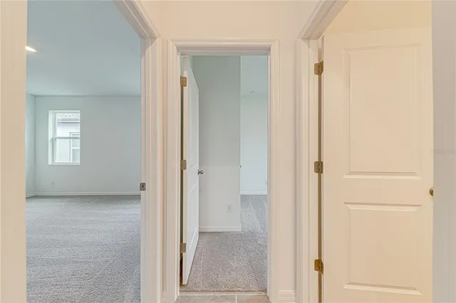 a view of an empty room with windows and closet