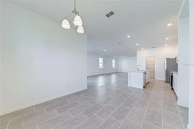 a view of a kitchen with a dishwasher and white cabinets