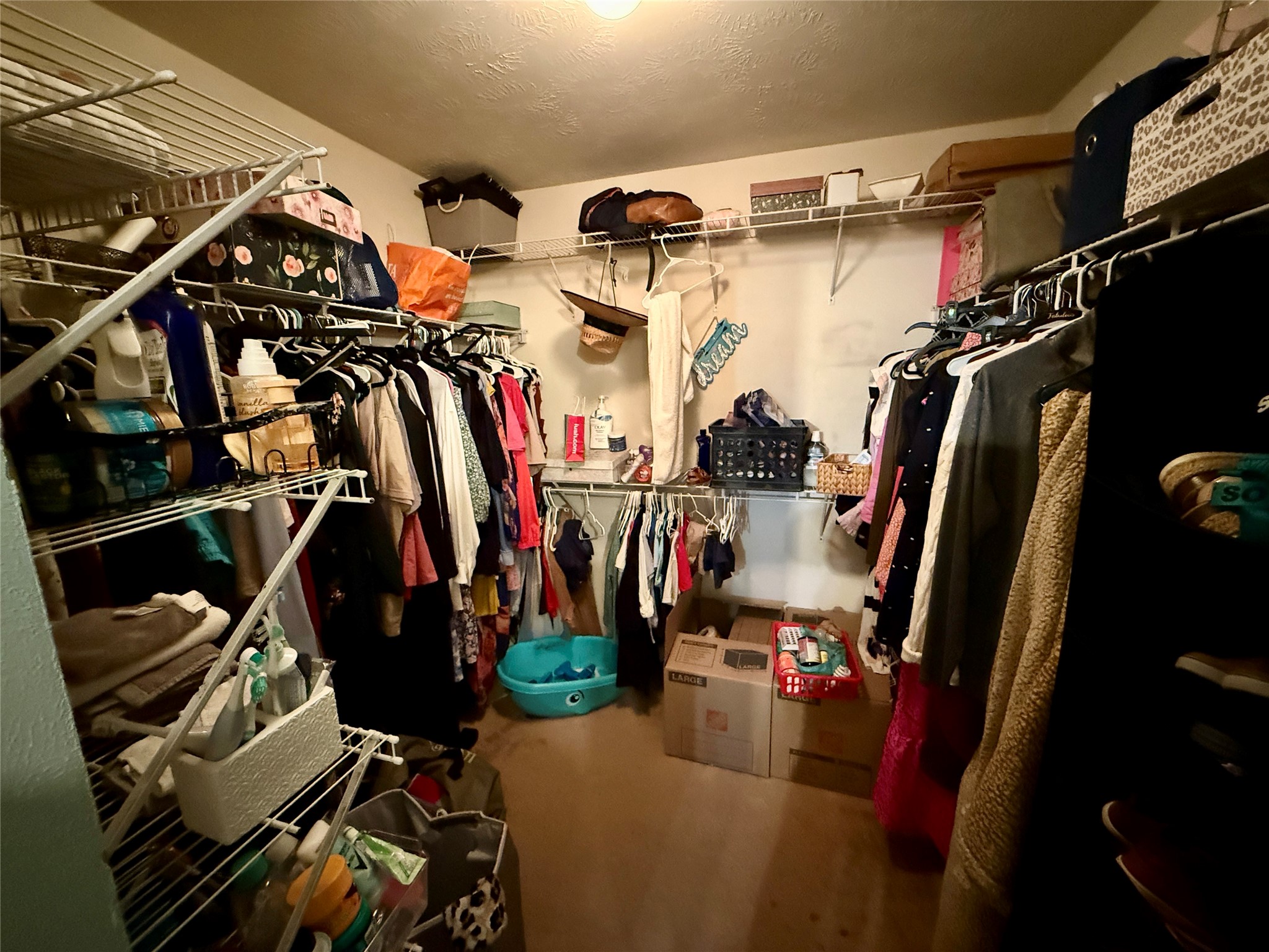 1022 Sycamore Ridge Lane Houston, TX 77073 - Photo 30 of 39 a view of walk in closet with clothes and shoes