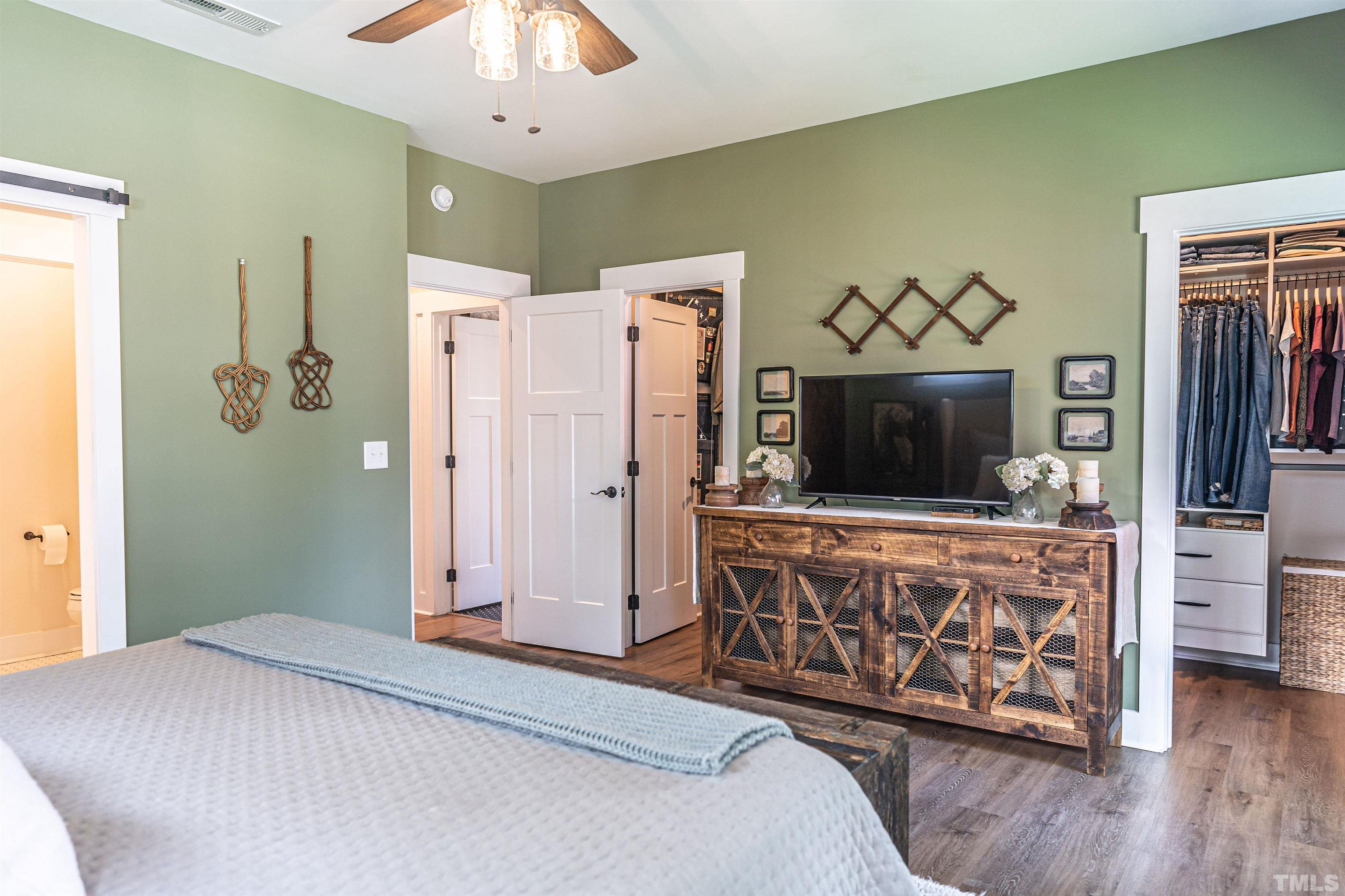 380 Sheldon Road Southern Pines, NC 28387 - Photo 14 of 32 a bedroom with a bed and a flat screen tv