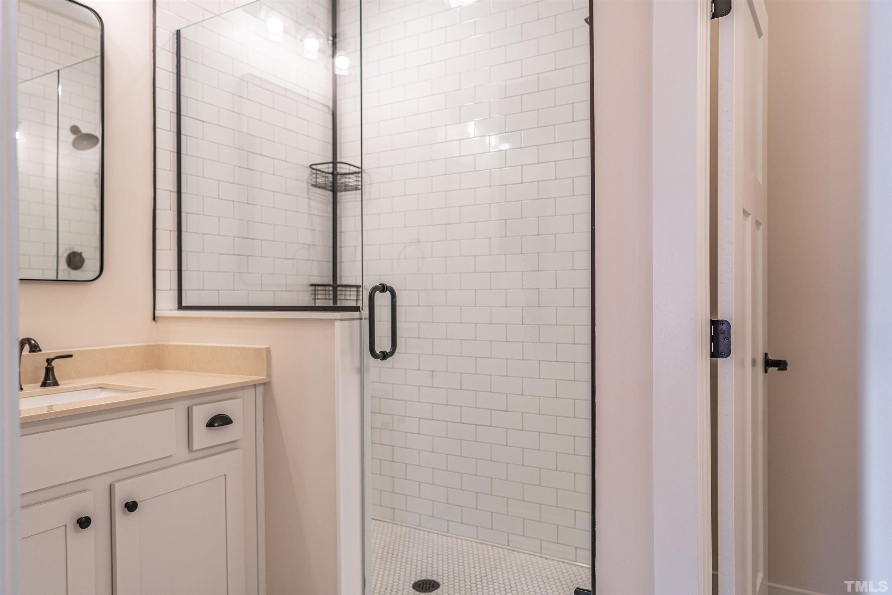 380 Sheldon Road Southern Pines, NC 28387 - Photo 18 of 32 a bathroom with a shower sink and mirror