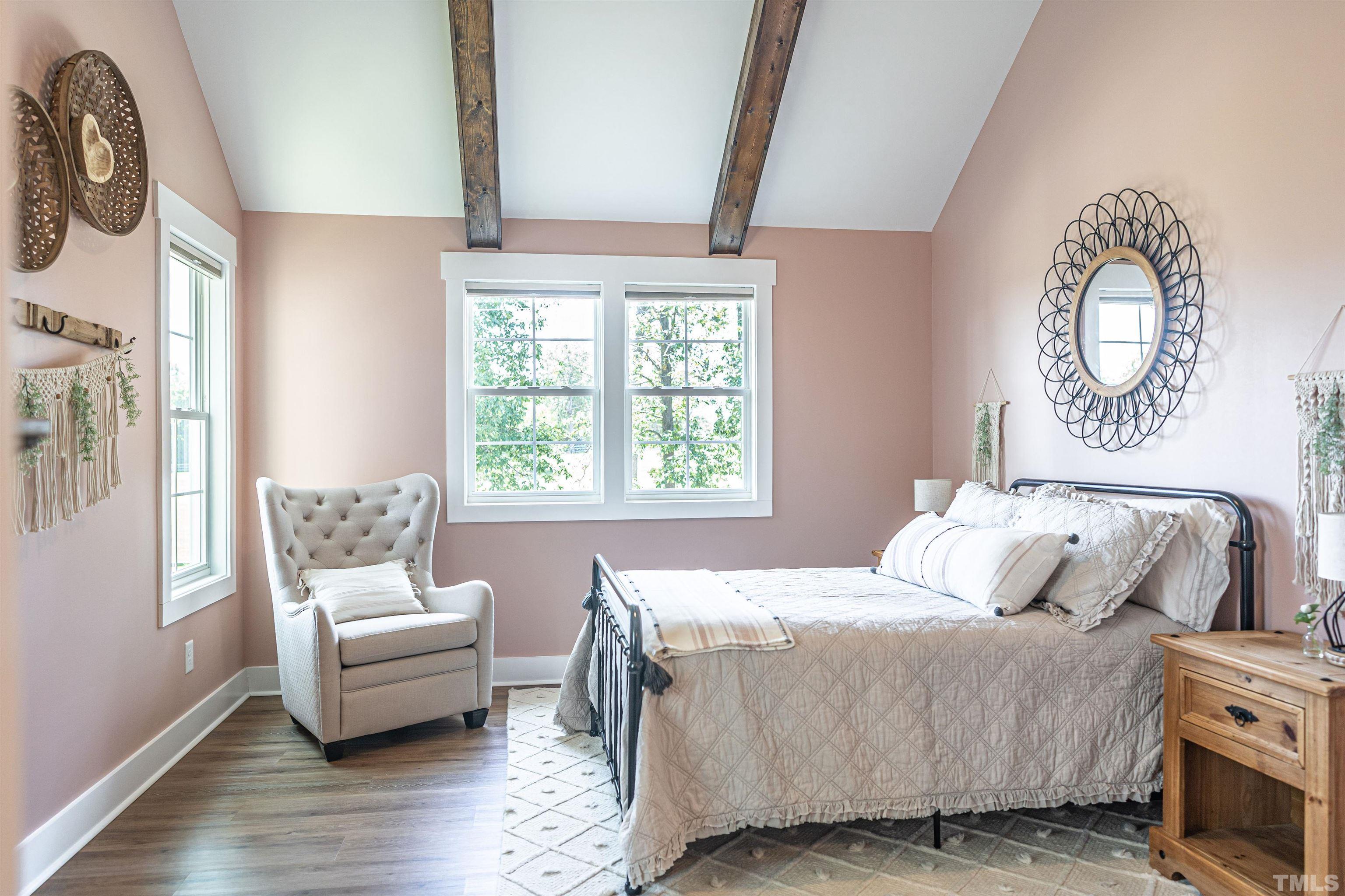 380 Sheldon Road Southern Pines, NC 28387 - Photo 24 of 32 a bedroom with a bed and a chair