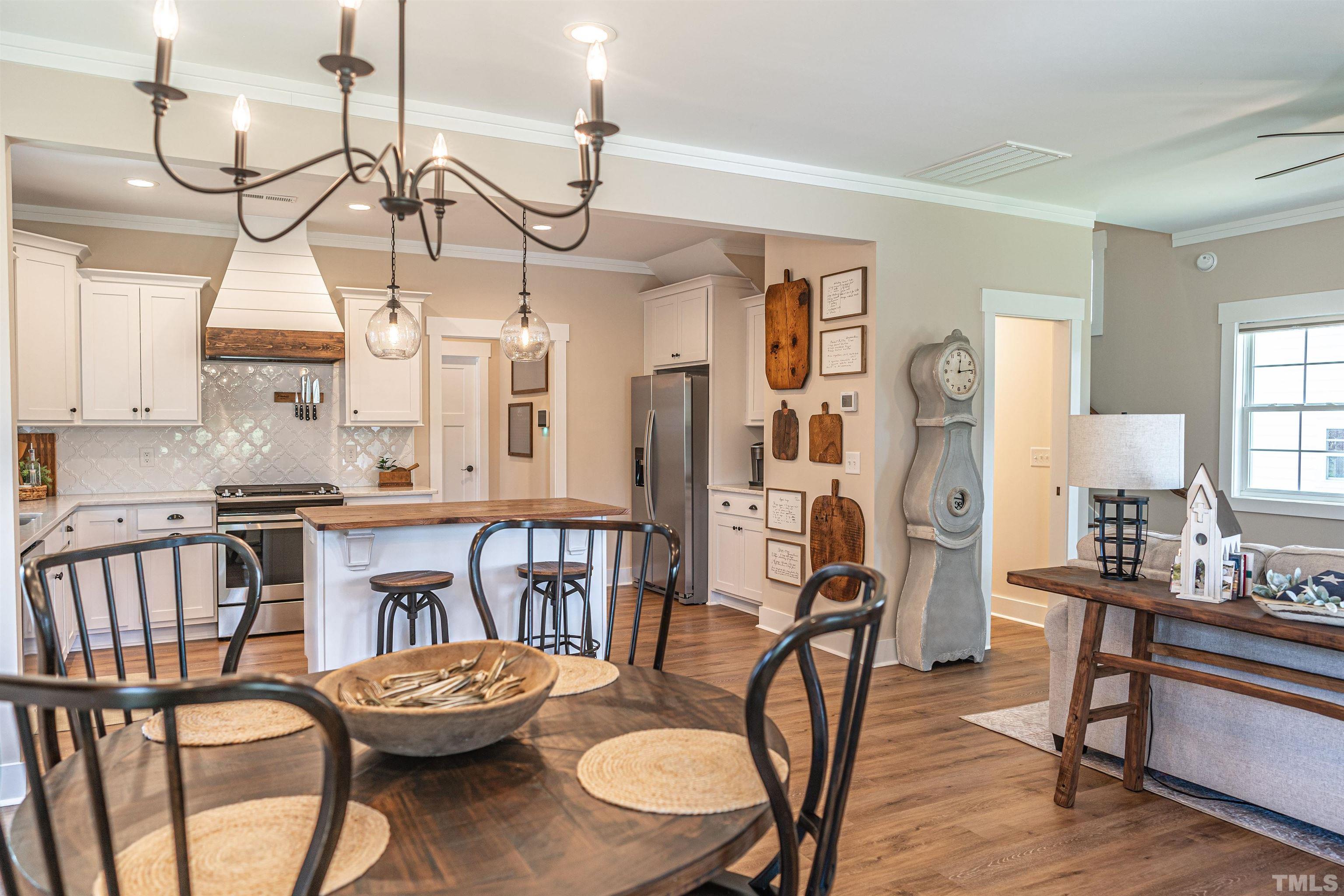 380 Sheldon Road Southern Pines, NC 28387 - Photo 3 of 32 a living room with furniture a dining table and chairs