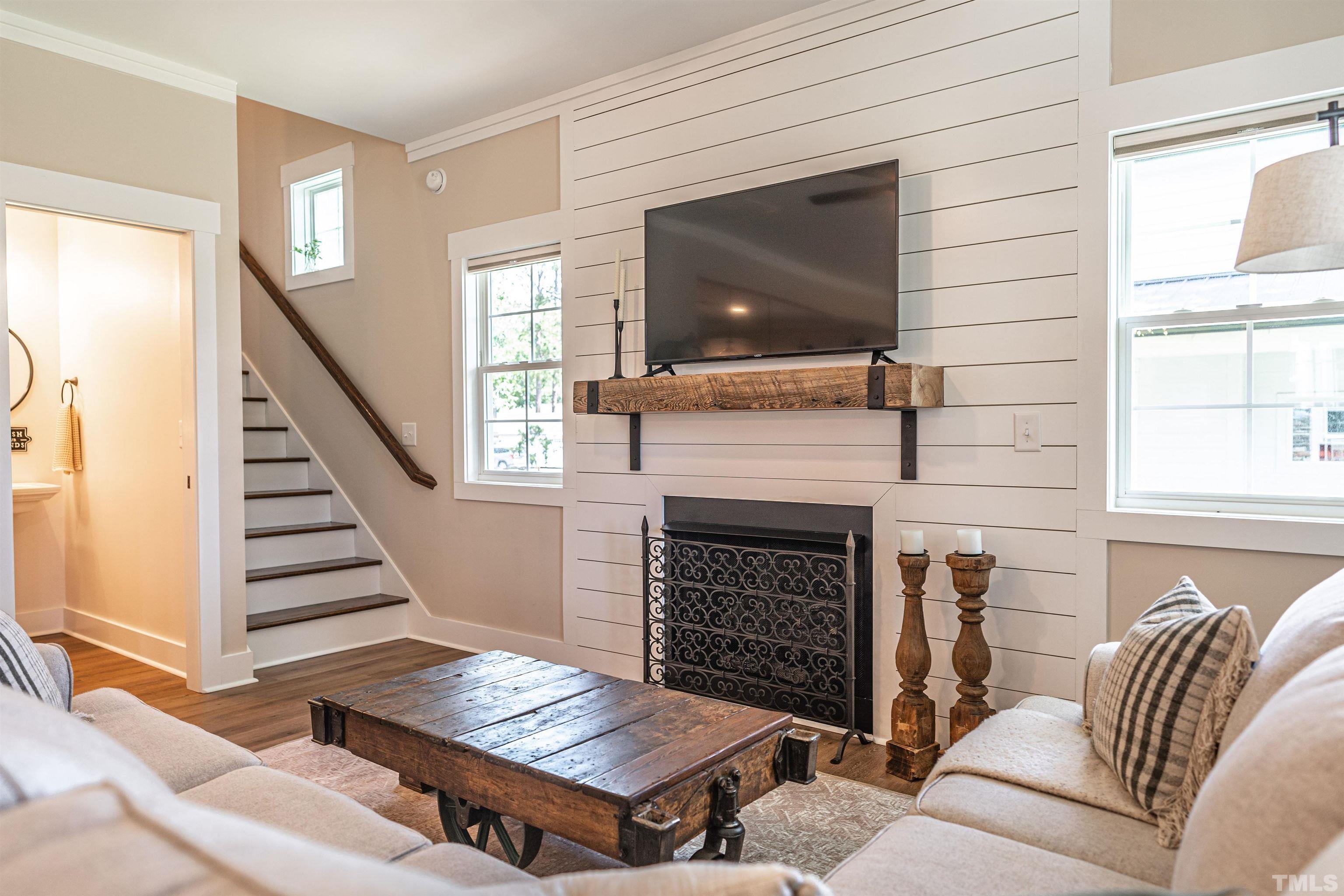 380 Sheldon Road Southern Pines, NC 28387 - Photo 5 of 32 a living room with furniture a flat screen tv and a fireplace