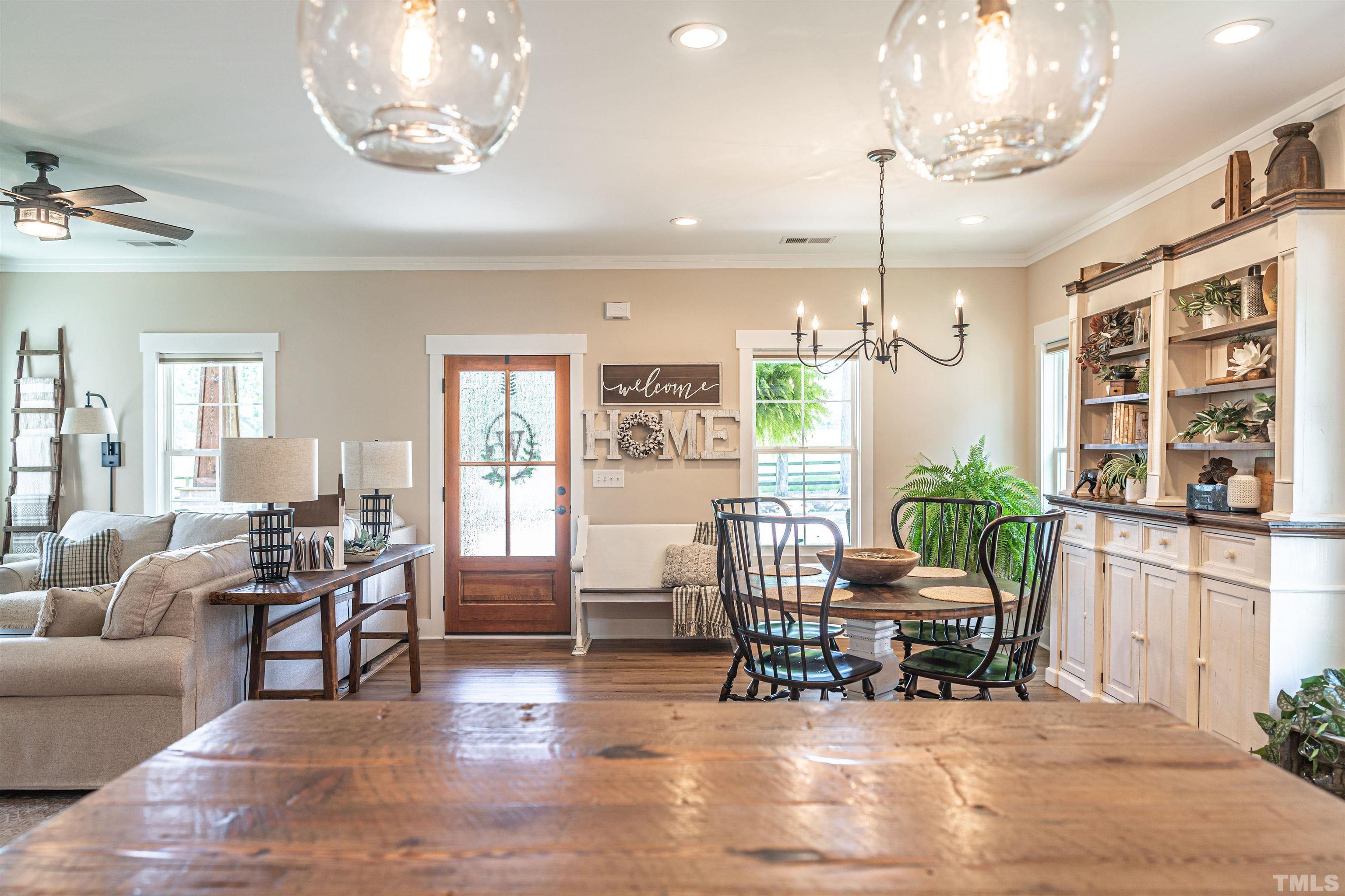 380 Sheldon Road Southern Pines, NC 28387 - Photo 6 of 32 a living room with furniture a chandelier and kitchen view