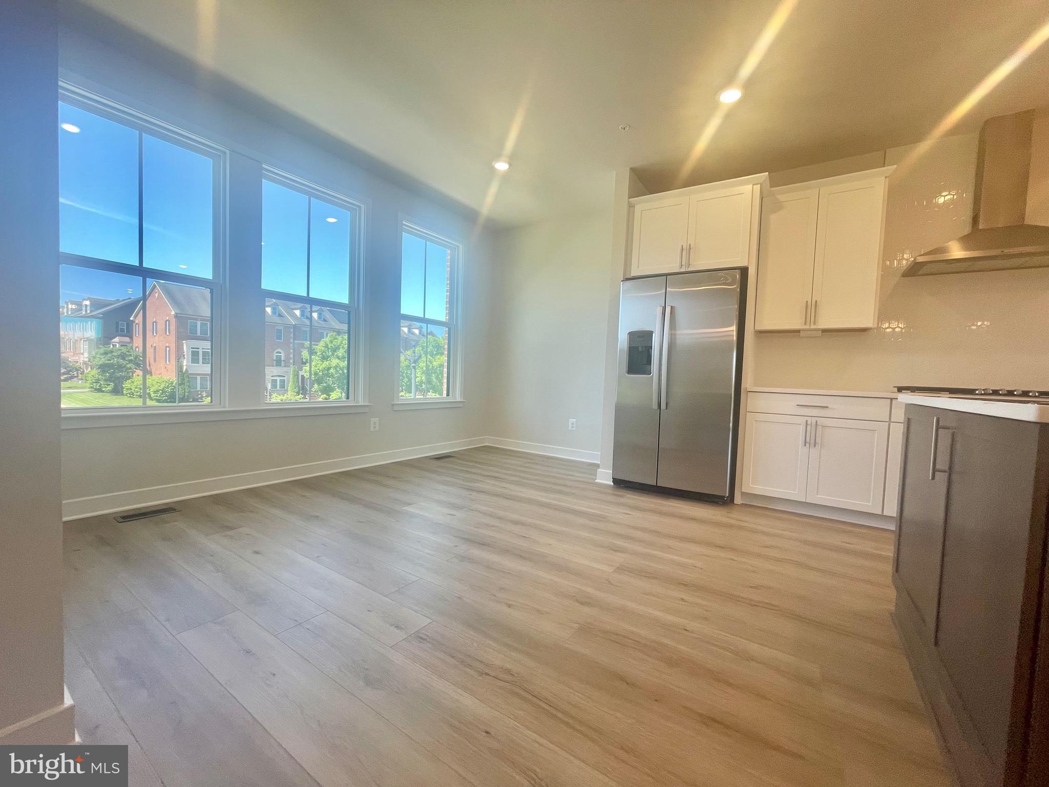 3563 Worthington Boulevard Frederick, MD 21704 - Photo 16 of 52 a view of a kitchen with wooden floor electronic appliances and windows