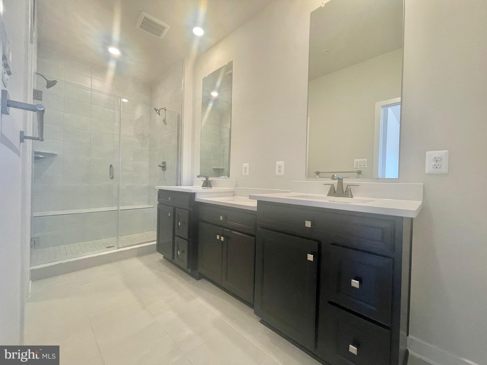 3563 Worthington Boulevard Frederick, MD 21704 - Photo 23 of 52 a bathroom with a double vanity sink a large mirror and shower