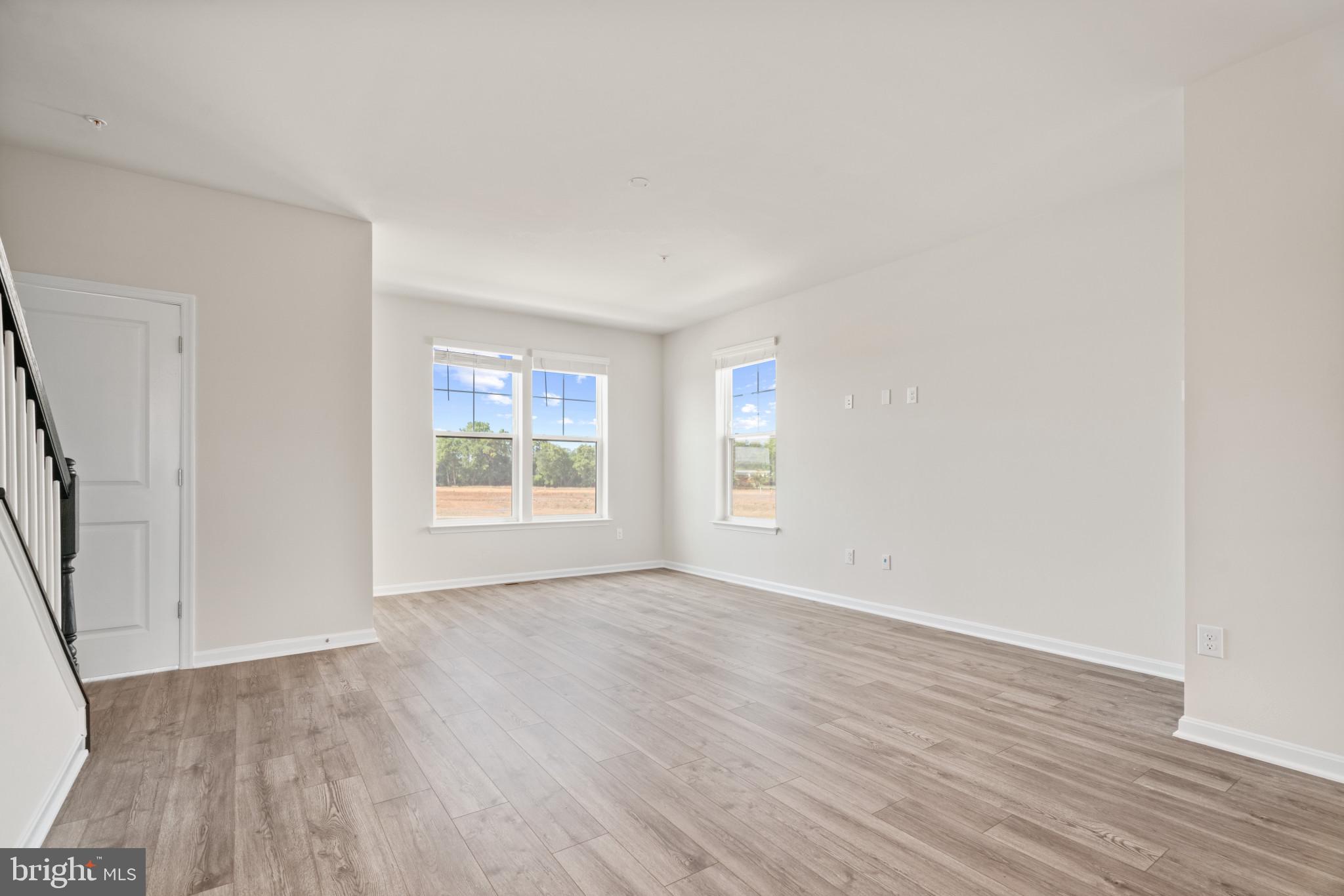 725 Compass Way Frederick, MD 21701 - Photo 12 of 47 an empty room with wooden floor and windows