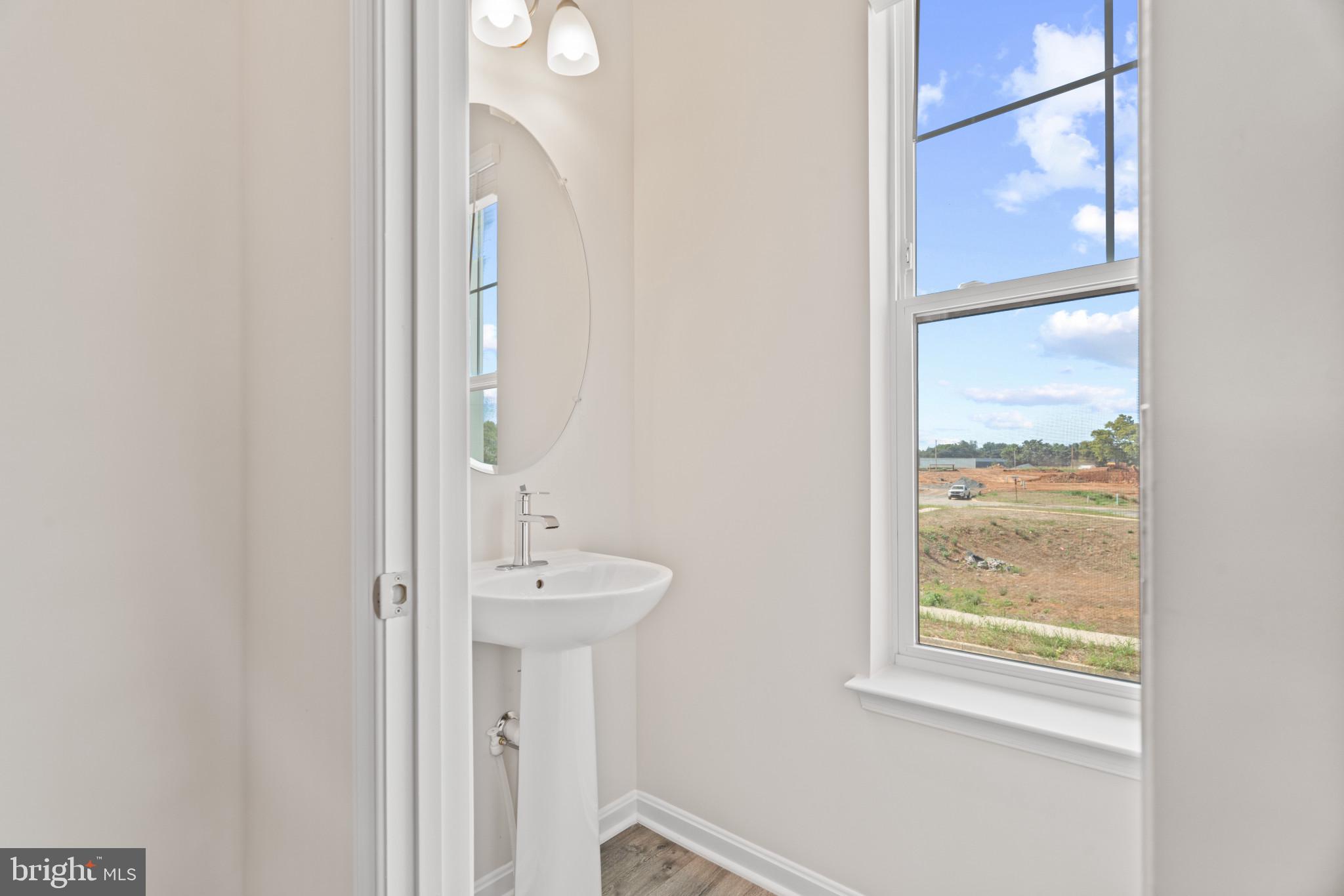 725 Compass Way Frederick, MD 21701 - Photo 14 of 47 a bathroom with a sink a mirror and a shower