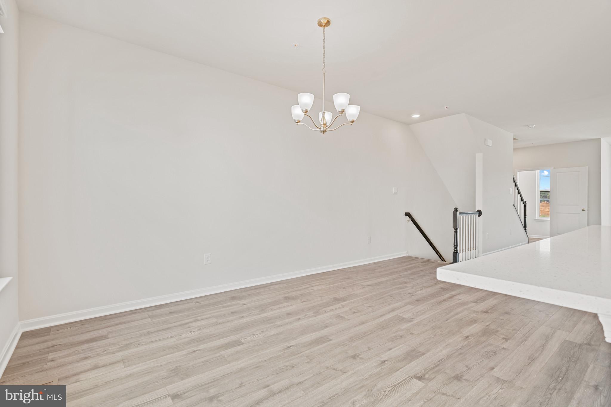 725 Compass Way Frederick, MD 21701 - Photo 32 of 47 a view of a room with wooden floor and staircase