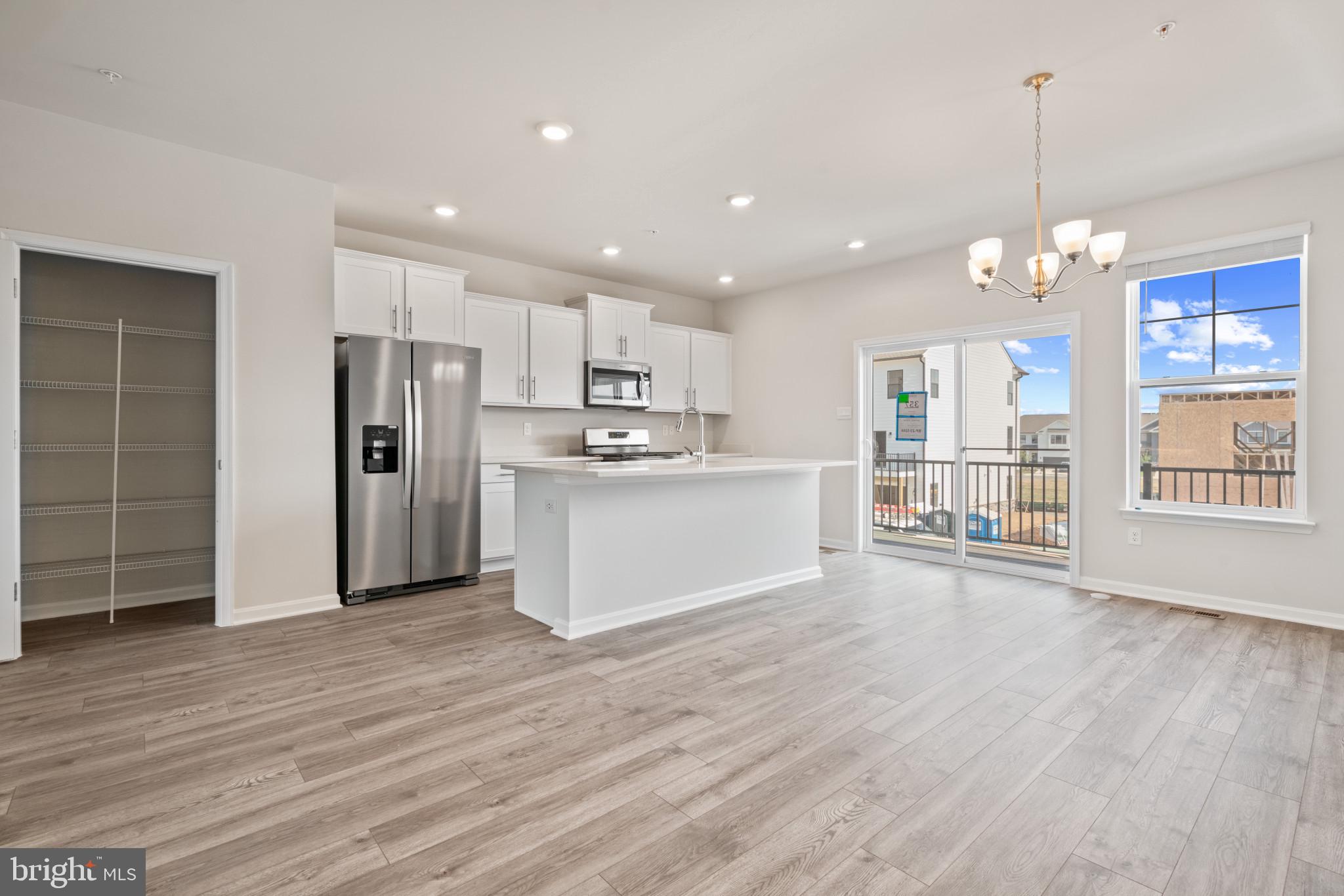 725 Compass Way Frederick, MD 21701 - Photo 9 of 47 a view of a kitchen with refrigerator and wooden floor