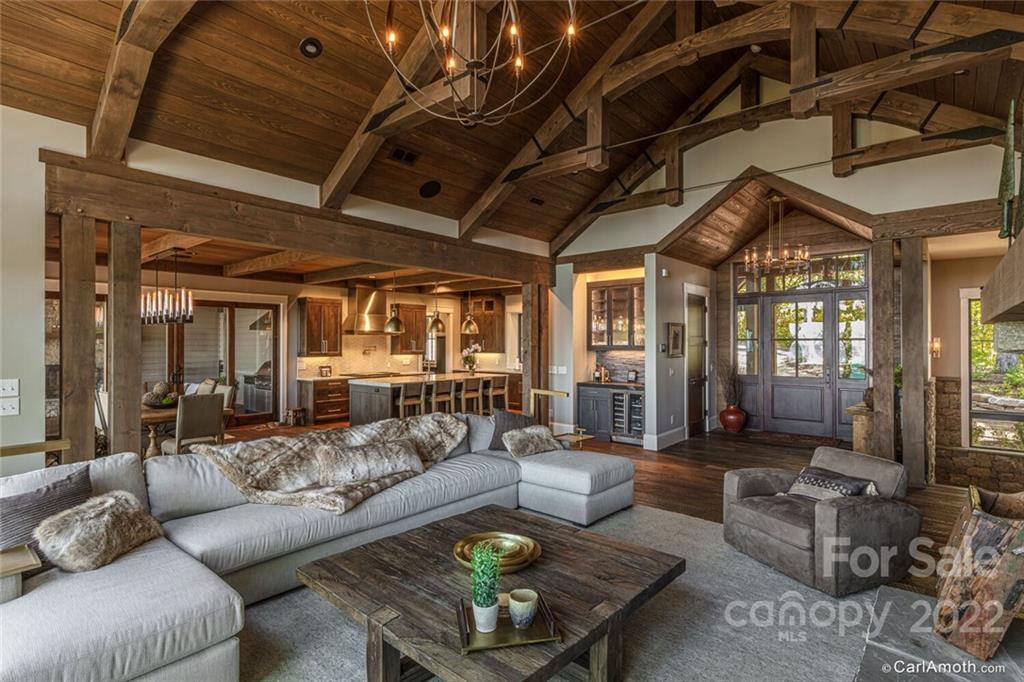 61 Back Bone Way, Unit 203 Sylva, NC 28779 - Photo 12 of 48 a living room with furniture and a chandelier